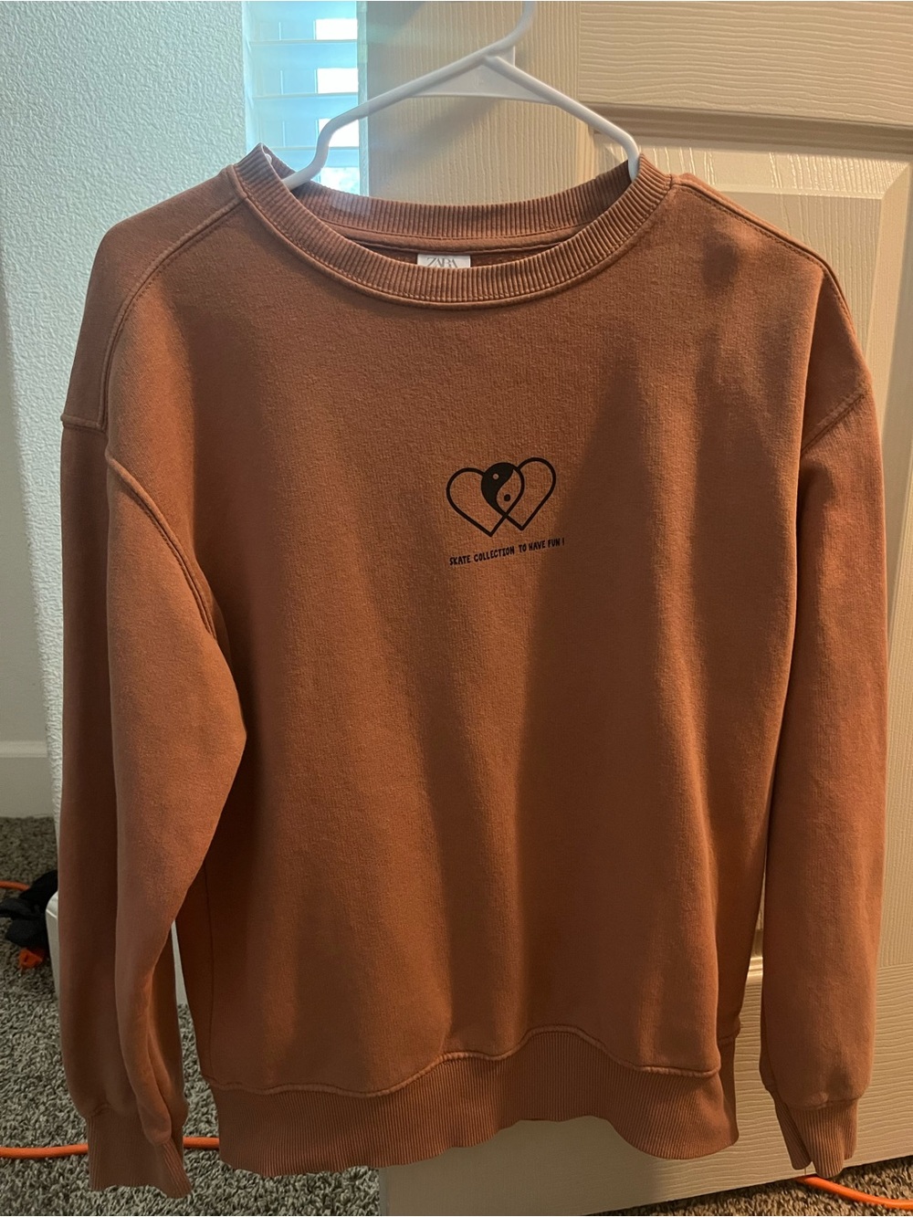 Girls’ orange Zara skater collection sweater